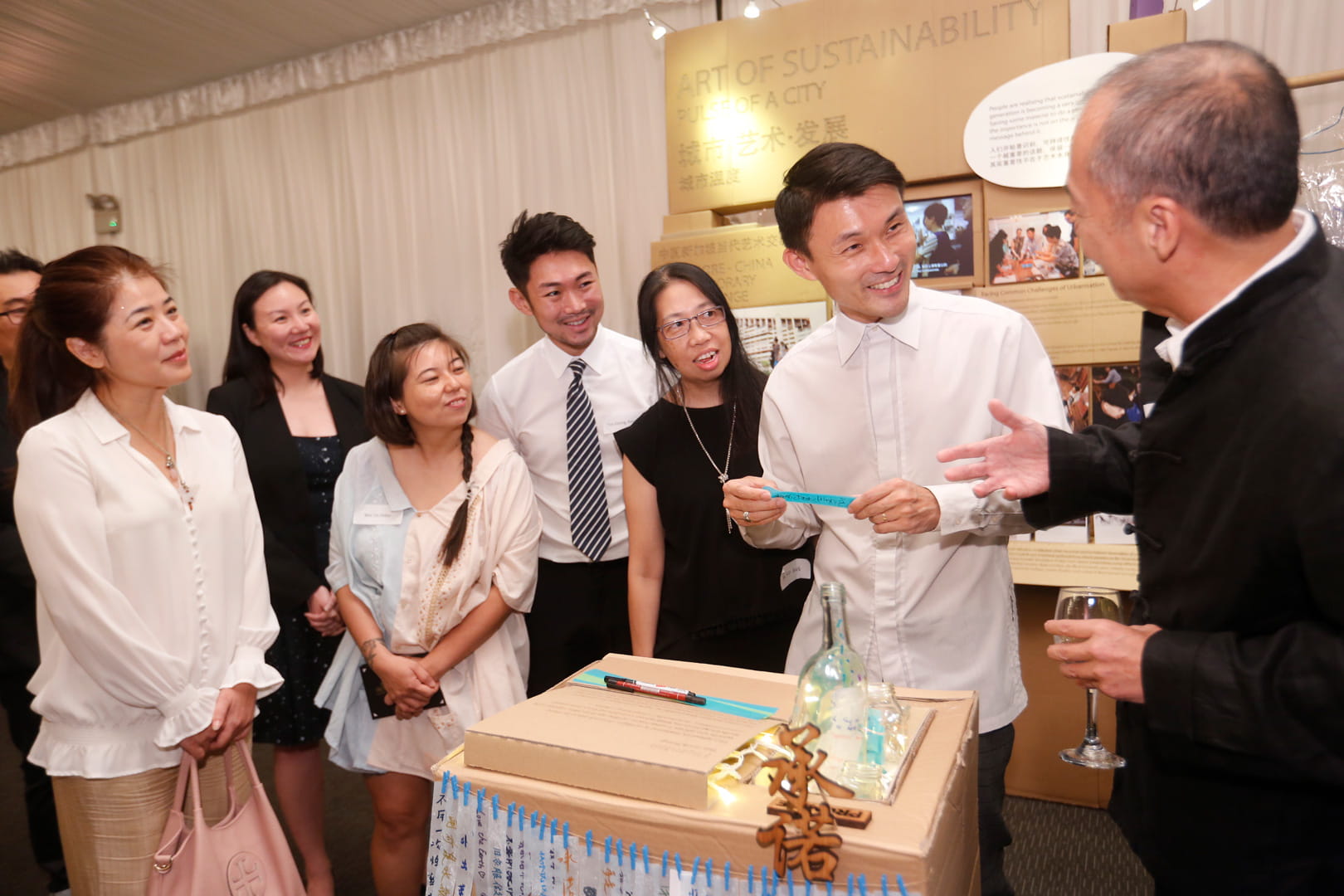 The Singapore International Foundation’s cultural ambassador Mr Sun Yu-li (extreme right) introducing the Art of Sustainability exhibit to guest-of-honour Parliamentary Secretary Mr Baey Yam Keng (second from right) at ShiOK! Nite